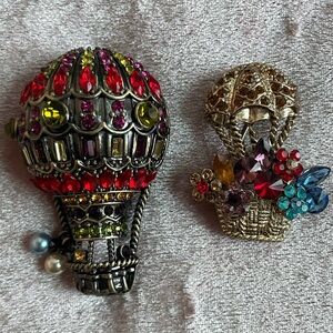 Two hot air ballon brooches.